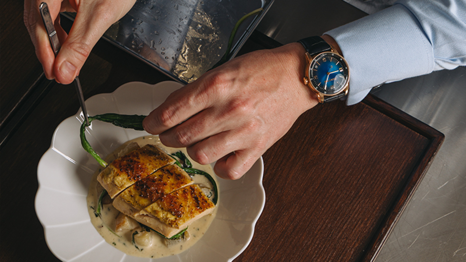 Chef Tristin Farmer, experienced 3-Star Michelin Chef, plating with precision at Maison Dalí Dubai